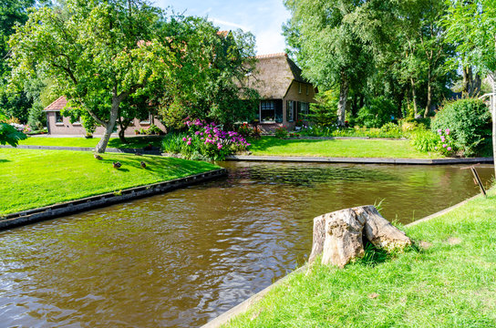 Giethoorn, Netherlands: Landscape view of famous Giethoorn village with canals and rustic thatched roof houses. The beautiful houses and gardening city is know as "Venice of the North".