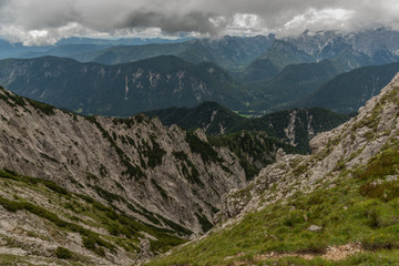 Fototapeta na wymiar View to Slovenia from path to Mittagskogel hill in cloudy summer day