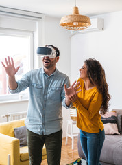Young couple enjoying having fun with virtual reality headset stock photo