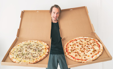 New York style pizzas takeout. Delivery man showing funny oversized pizza boxes delivery fast food...