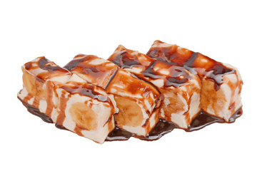 Dessert sweet rolls with bananas, poured with chocolate syrup. Isolated on a white background, close-up