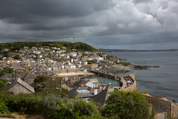 Dark clouds over Mousehole Harbour in Cornwall UK