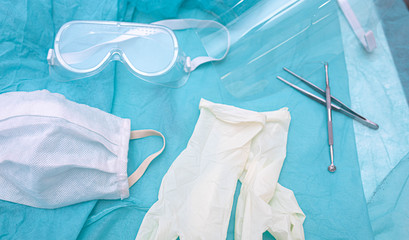 Medical gloves, mask, glasses in surgery.