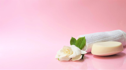 Fototapeta na wymiar Spa setting and Spa background composition with white gardenia flower on pink background. Banner
