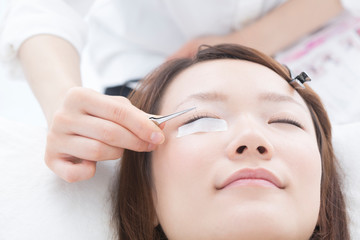 まつ毛エクステをする女性