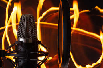 Microphone against the background of fire, spectacular photo, vocal recording