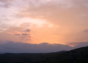 Sunset in the high mountains with clouds