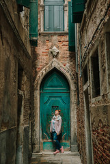 european girl in the alley with old buildings and architecture