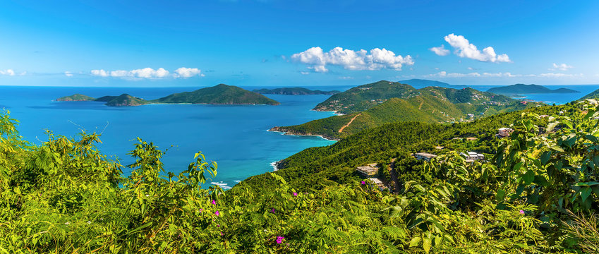 A view past lush vegetation towards the islands of Guana, Great Camanoe and Scrub from the main island of Tortola