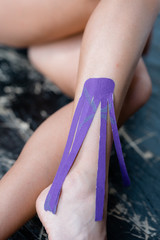 Kinesio tape applied to a woman's leg