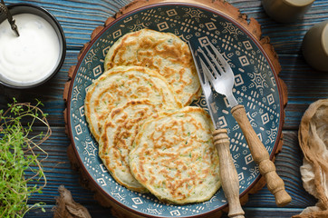 Zucchini pancakes with thyme and sour cream