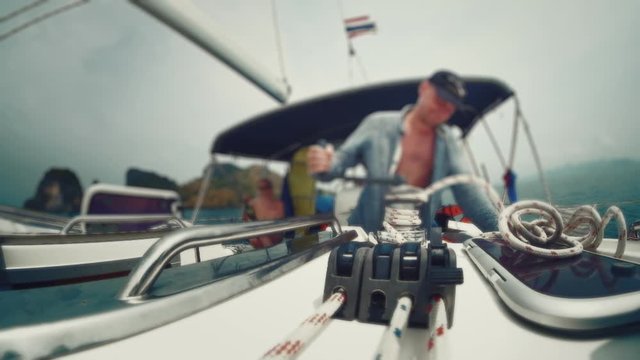 Man on the boat. Man works with winch on the sailing boat