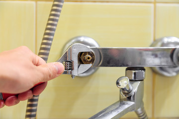 Plumber replaces valve on water tap
