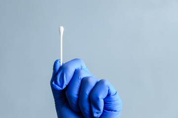 A cotton swab in the hands of a medic