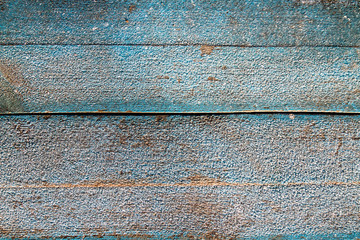 Wooden blue Board covered with crystals of frost, ice. Winter frosty background. The texture of the frost.