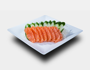 slices of salmon sashimi, served on a white plate. isolated