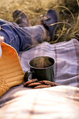Cup of hot drink with steam in sunset 