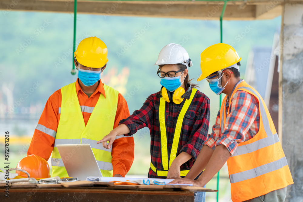 Aufkleber team of engineer and architects wearing protective mask to protect against covid-19 using laptop at 
