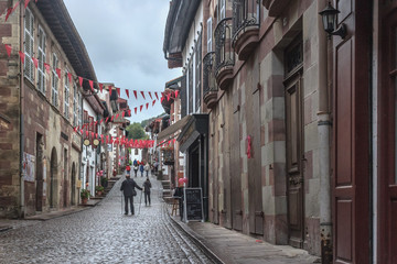 Fototapeta premium City of pilgrimage Saint-Jean-Pied-de-Port in the Antlantic Pyrenees. Station on the Way of St. Jacob. The Pilgrim's Way. Tourist location. Popular cities in France. Europe's narrow cobbled street.