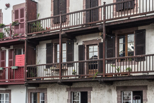 Rhythm in photography. Clear lines and geometry in architecture. The facade of an old house. Wooden railing balconies. Apartment building. Budget housing. Open balconies and shuttered windows.