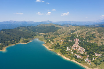 Fototapeta na wymiar panoramic aerial view of the village of mascioni on lake campotosto in the mountain area of gran sasso italy
