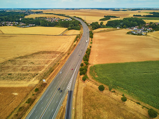 Aerial drone view of beautiful French countryside and six-lane motorway