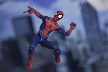 Fototapeta premium NEW YORK USA, AUGUST 21 2020: Spiderman from Marvel Comics and The Avengers swinging from a web - Hasbro action figure