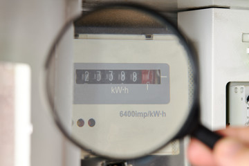 energy meter at white electricity box indoors. domestic life. check power consumption
