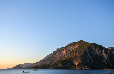 Beautiful orange sunrise on the Mediterranean Sea shore at Olympos coast, Cirali village, Turkey