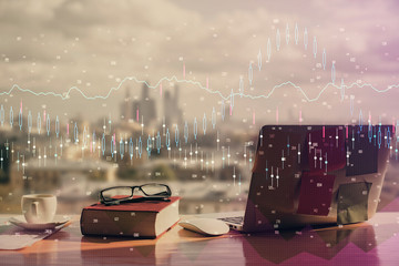 Double exposure of financial chart drawings and desk with open notebook background. Concept of forex market