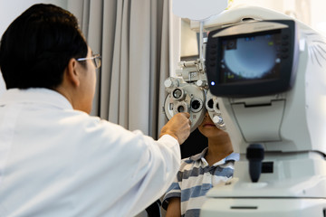 optometrists are examining pediatric patients' eyes with the Autorefractor
