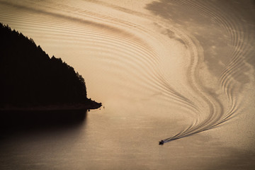 Early Start - A lone boat sprints to a favorite fishing hole. Detroit Lake, Oregon, USA