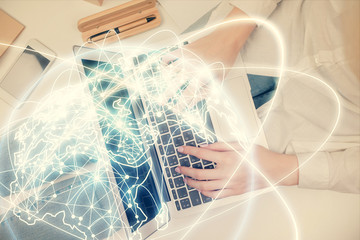 Double exposure of woman hands working on computer and financial theme hologram drawing. Top View. Business concept.