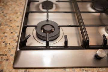 Dirty gas stove stained while cooking, a stove in grease. Unsanitary conditions, a mess in the...
