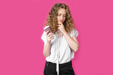 Young woman holds coffee in her hands and thinks.