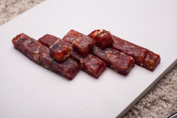 Pile of oriental sweets with nuts, seeds and rose petals, close-up shot, selective focus