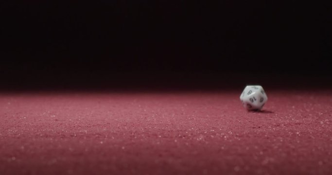 Wide of White 20-Sided Dice Rolling in Slow Motion Revealing 18 Side