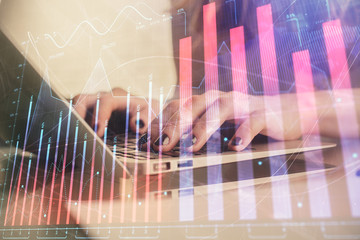 Double exposure of woman hands typing on computer and forex chart hologram drawing. Stock market...