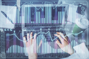 Double exposure of woman hands typing on computer and forex chart hologram drawing. Stock market invest concept.