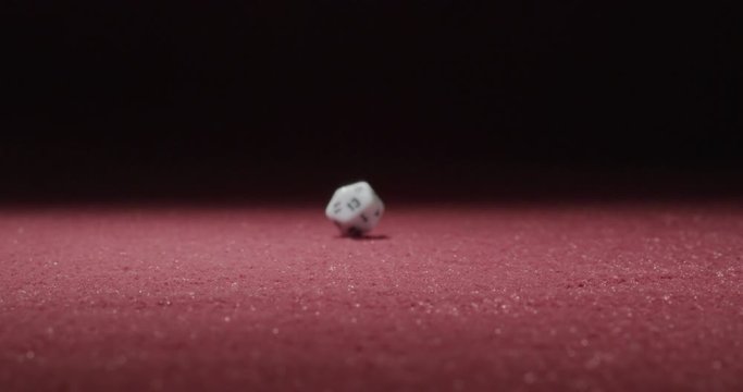 Wide of White 20-Sided Dice Rolling in Slow Motion Revealing 5 Side