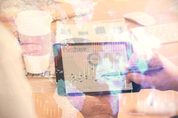 Double exposure of man's hands holding and using a phone and financial chart drawing. Market analysis concept.