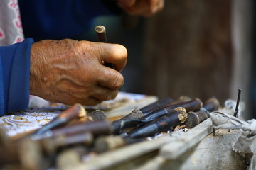close up of a man working on a wooden floor