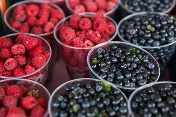 background of raspberries and blueberries in the market