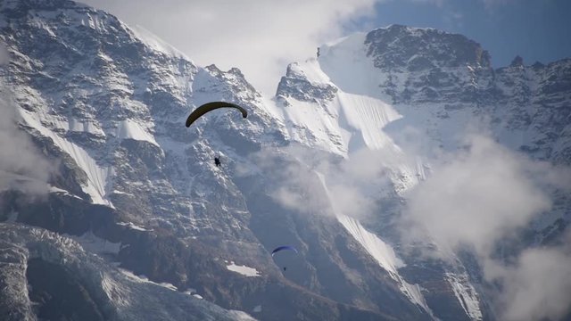 Beautiful view of Paraglider flying near the Jungfrau mountain in Switzerland