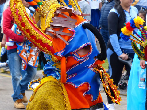 Dancer dressed in masks as characters of Inti Raymi celebration called Devil Huma at the  at the traditional parade for day independence of Cuenca, Ecuador