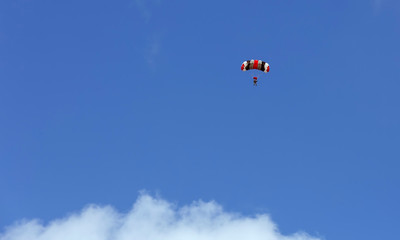 Obraz na płótnie Canvas Parachuter floats weightless above ground after deploying his chute