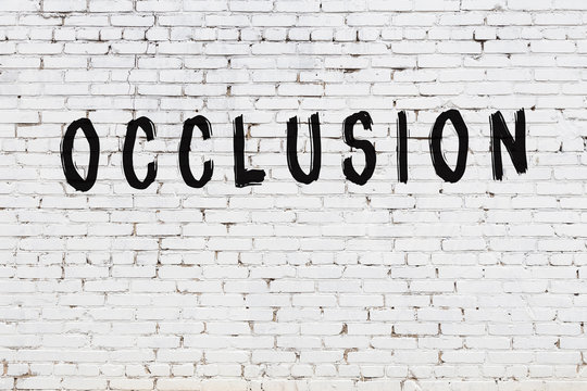 Inscription occlusion painted on white brick wall