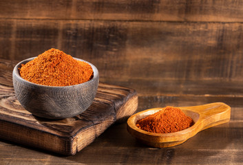 Paprika powder in a wooden bowl - Capsicum annuum