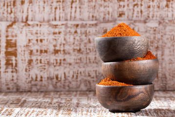 Paprika powder in a wooden bowl - Capsicum annuum