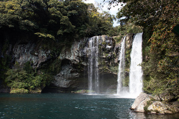 Fototapeta na wymiar Cheonjiyeon Waterfall on Jeju Island in South Korea